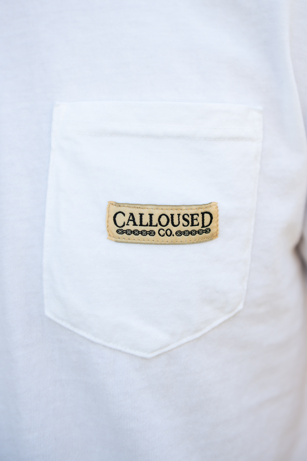 White shirt with a 'Calloused Co' logo patch on a white background