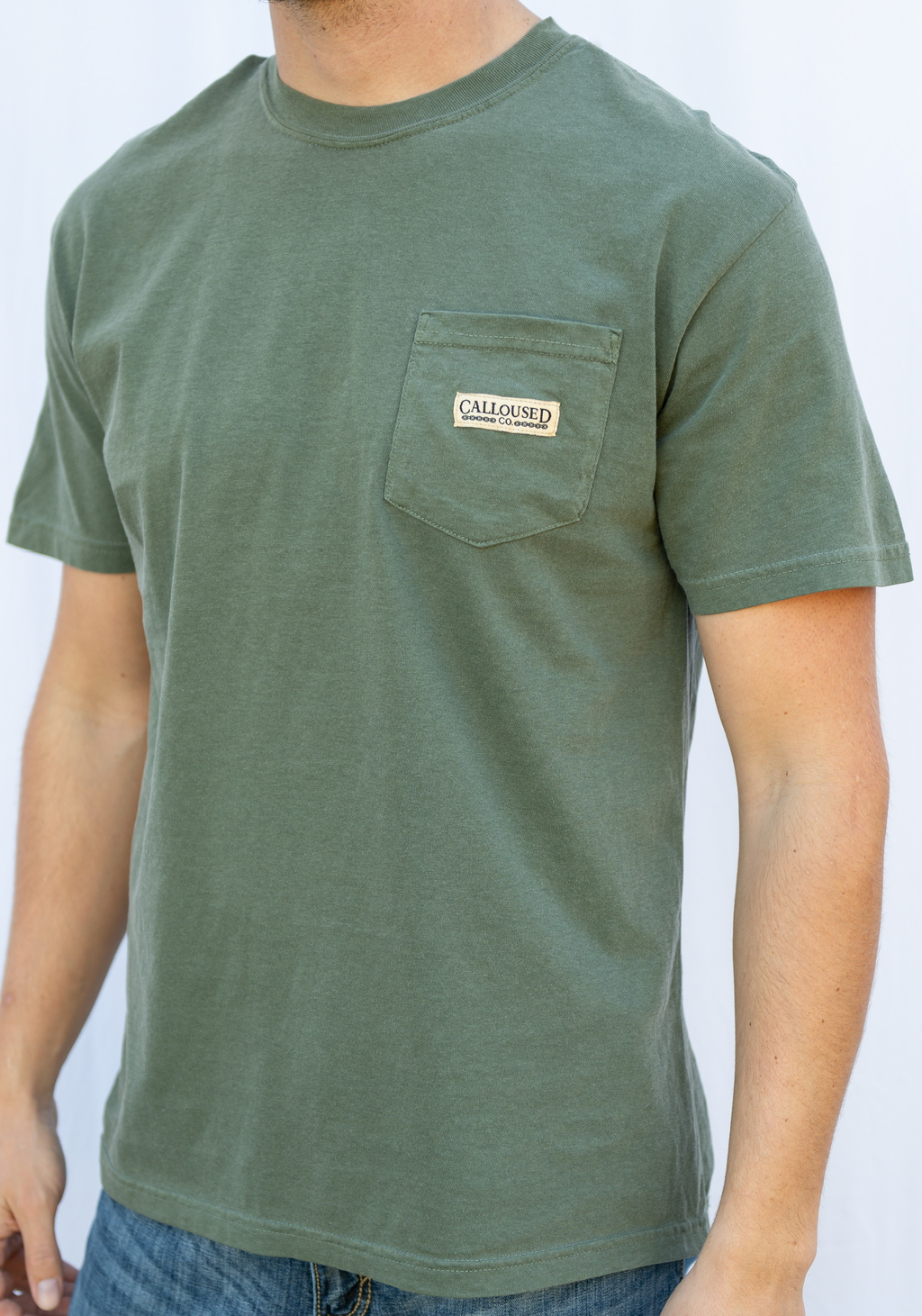 Green t-shirt with 'Calloused Co' brand logo on a plain background