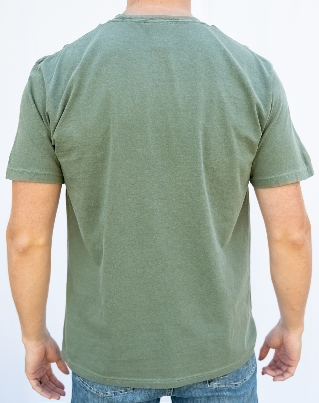 Green t-shirt worn by a person on a white background