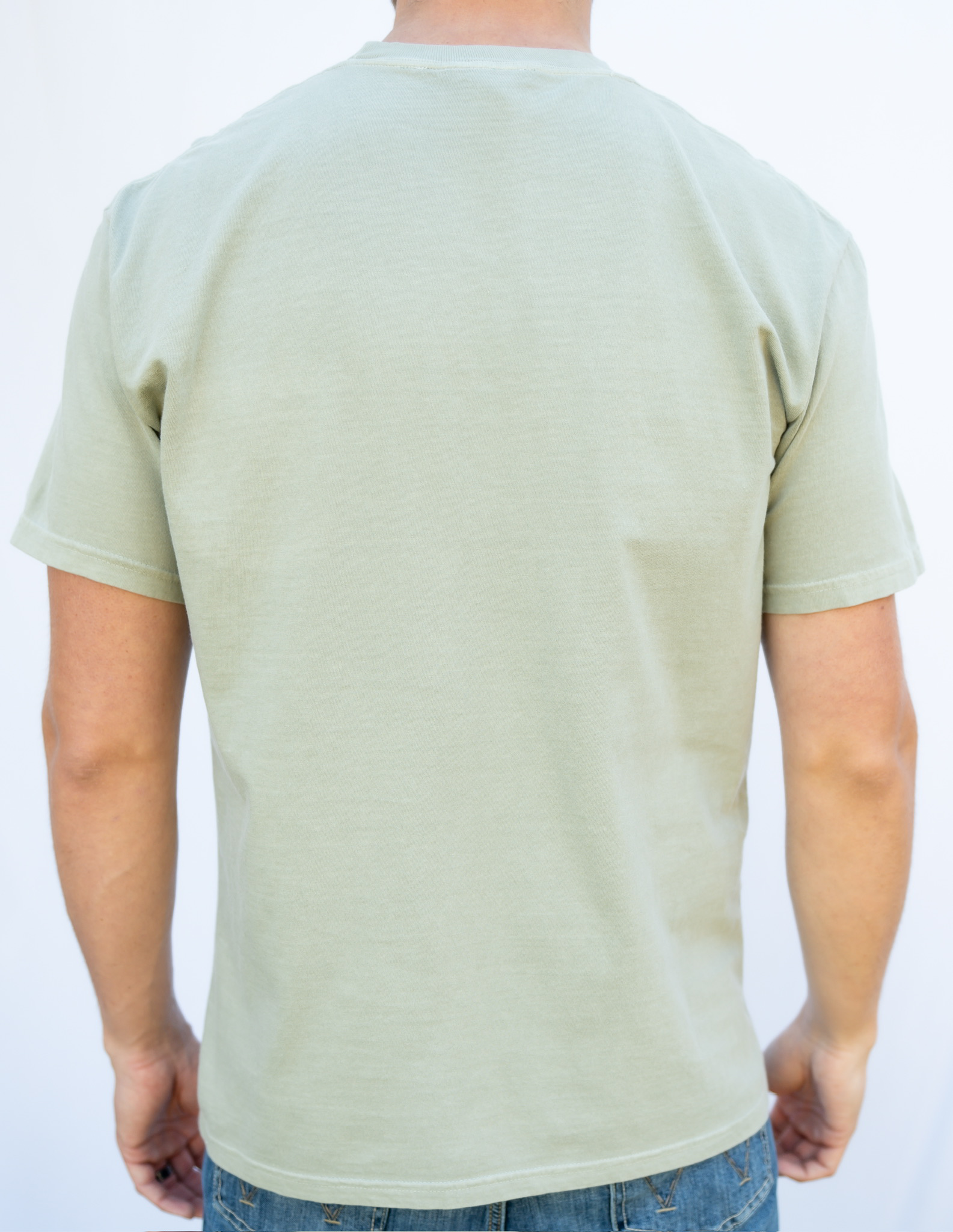 Person wearing a sandstone t-shirt on a white background
