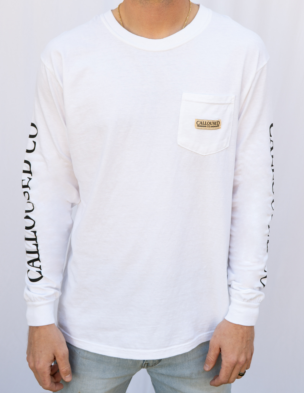 White long-sleeve shirt with 'Calloused Co' branding on a plain background